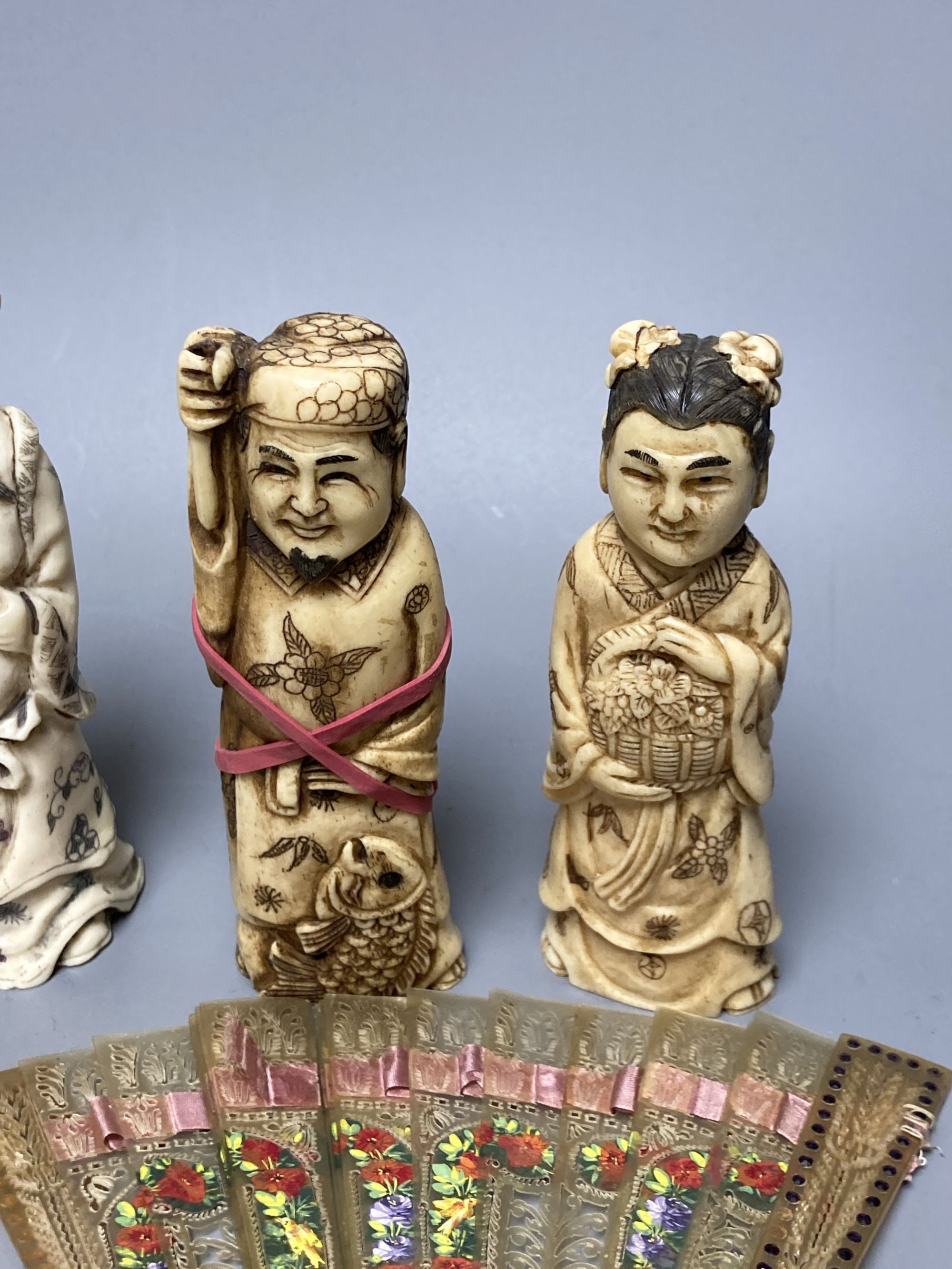 A quantity of bone and ivory carvings including fans and figures